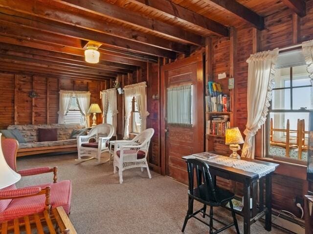 interior space featuring wooden ceiling, wooden walls, carpet flooring, and beam ceiling