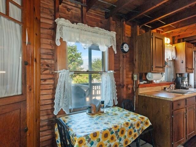 kitchen with beam ceiling and sink