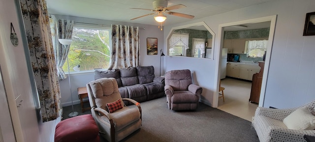 carpeted living room with ceiling fan