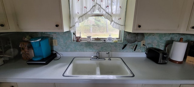 kitchen with sink and white cabinets