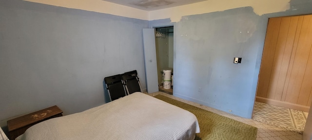 bedroom featuring wooden walls