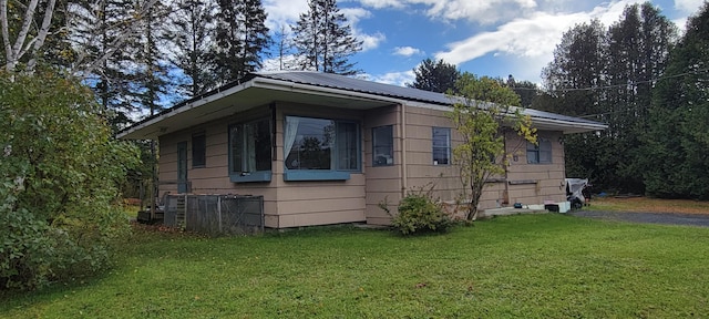 view of property exterior featuring a lawn