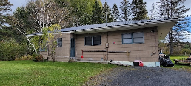 view of property exterior featuring a lawn