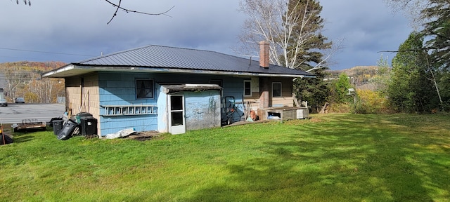 back of property featuring a lawn