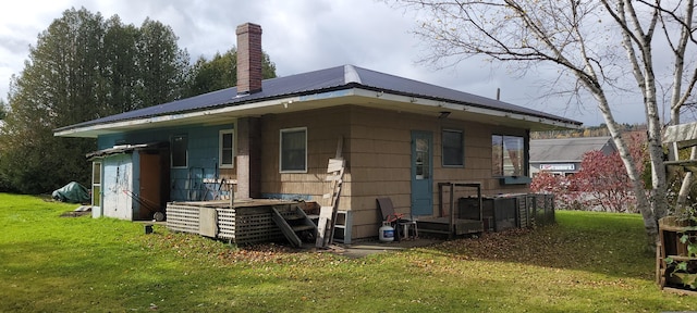 rear view of property with a yard