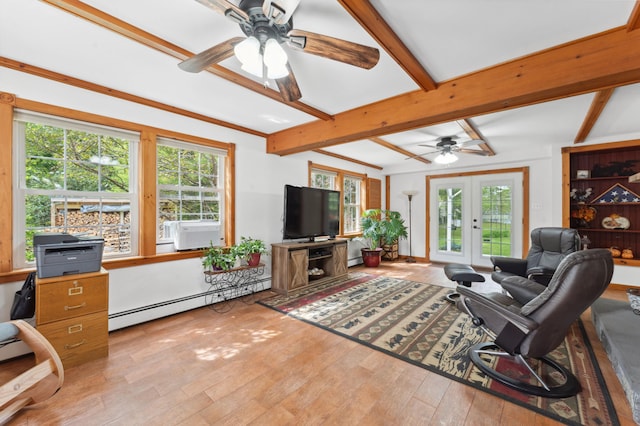 living room with a healthy amount of sunlight, ceiling fan, baseboard heating, and french doors