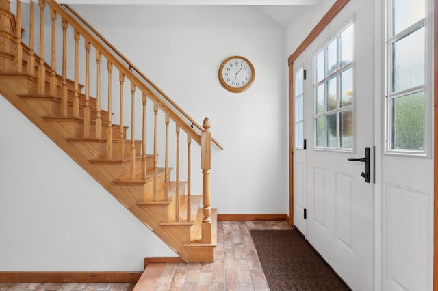 foyer with a healthy amount of sunlight and hardwood / wood-style flooring