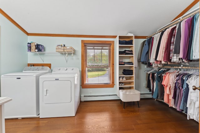 clothes washing area with wood-type flooring, baseboard heating, ornamental molding, and washing machine and clothes dryer