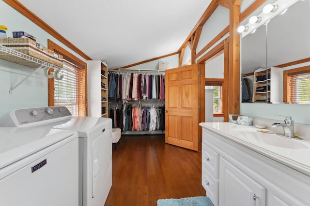 washroom featuring separate washer and dryer, dark wood-type flooring, crown molding, and sink