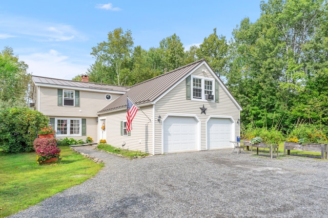 view of front of home with a garage and a front lawn