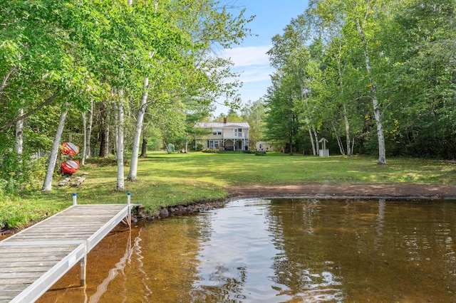 dock area with a yard and a water view