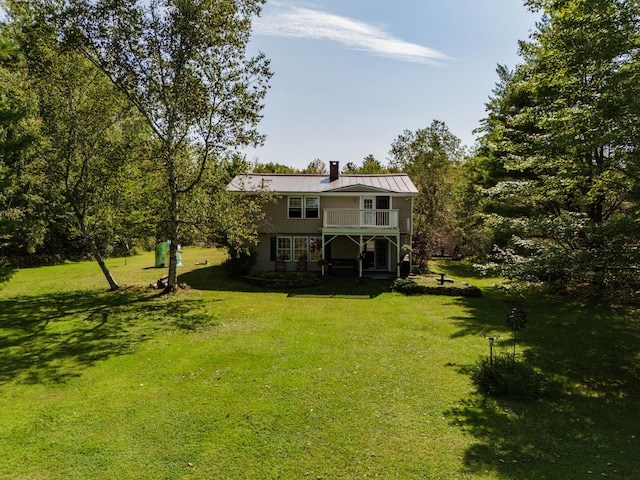 exterior space with a balcony and a yard