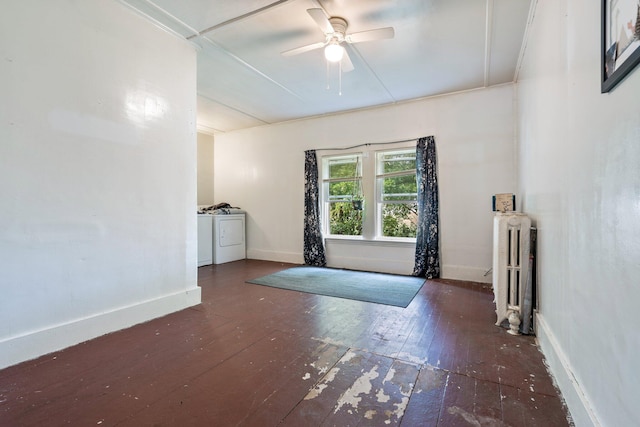 unfurnished room with separate washer and dryer, radiator, dark hardwood / wood-style flooring, and ceiling fan