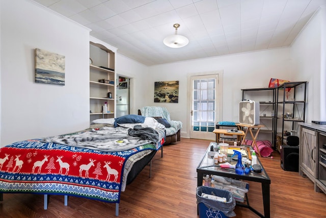 bedroom featuring wood-type flooring and ornamental molding