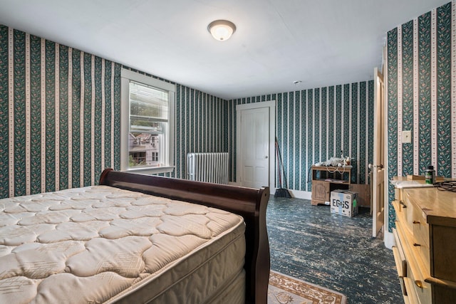 bedroom featuring wallpapered walls and baseboards