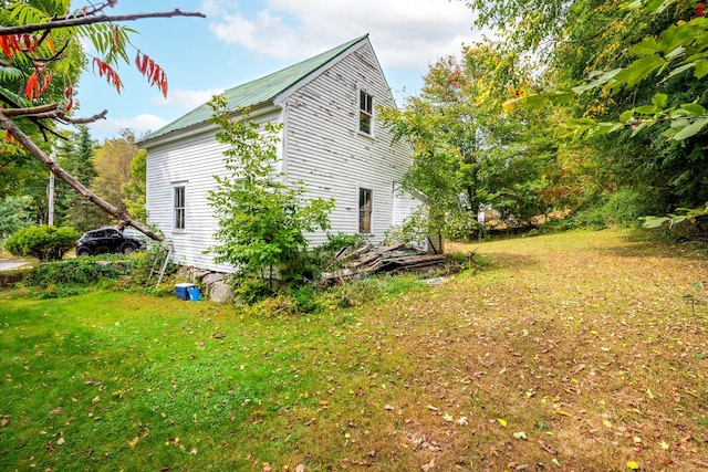 view of property exterior with a lawn