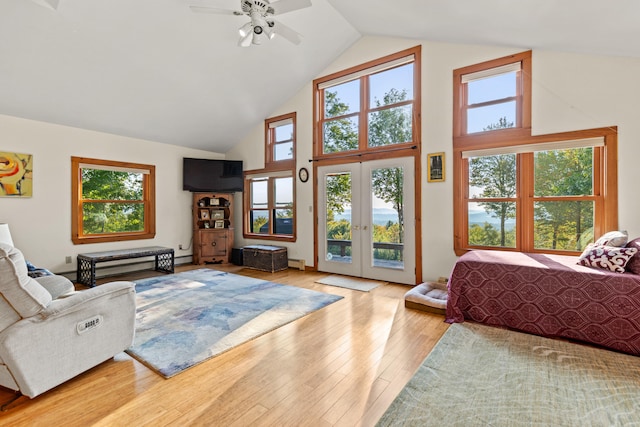 bedroom with access to outside, multiple windows, ceiling fan, and wood-type flooring