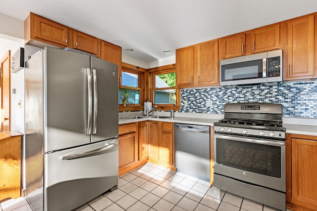 kitchen featuring appliances with stainless steel finishes, tasteful backsplash, and light tile patterned floors