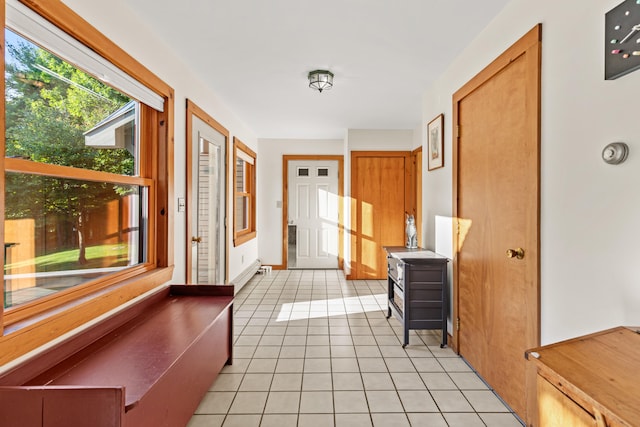 doorway to outside with light tile patterned floors