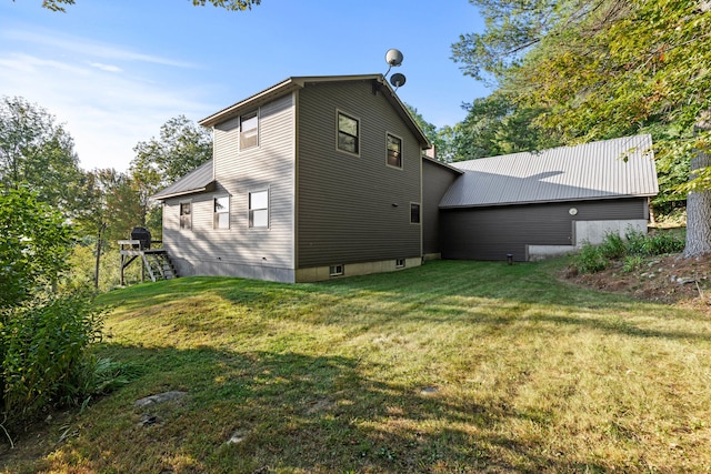 rear view of property with a lawn