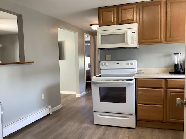 kitchen with baseboard heating, dark hardwood / wood-style floors, and white appliances