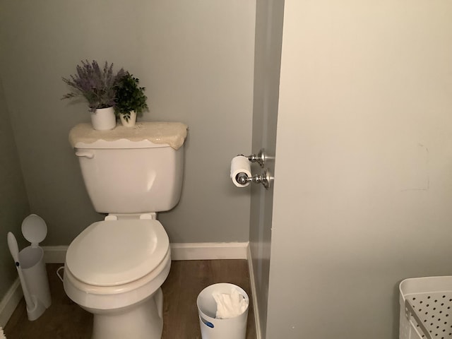 bathroom with hardwood / wood-style floors and toilet