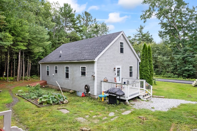 back of house with a wooden deck and a yard