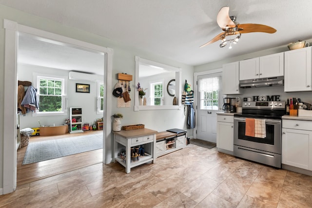 kitchen with light hardwood / wood-style floors, ceiling fan, electric range, and white cabinets