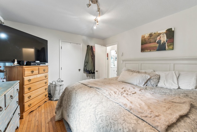 bedroom with wood-type flooring and a closet