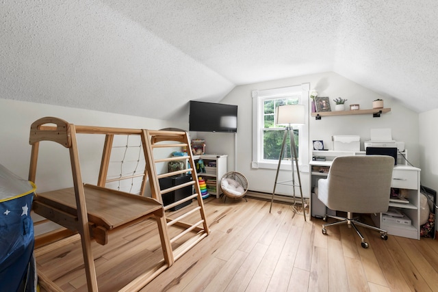 office area with a textured ceiling, light hardwood / wood-style flooring, and lofted ceiling