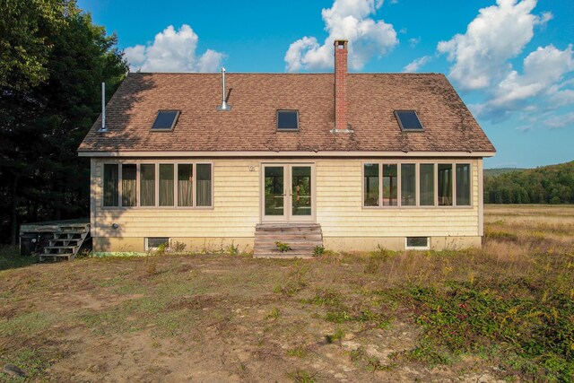 back of property with a sunroom