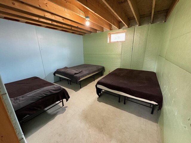 bedroom featuring concrete floors