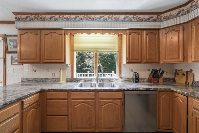 kitchen featuring backsplash, sink, and stainless steel dishwasher