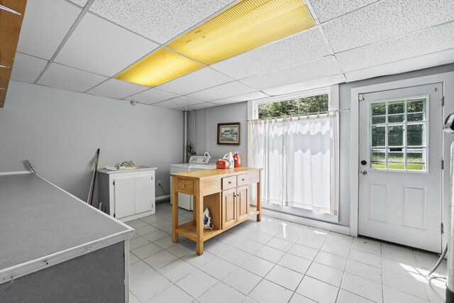 interior space featuring sink, light tile patterned floors, and a paneled ceiling