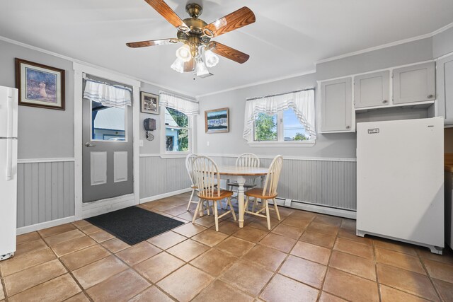 dining space with ornamental molding, ceiling fan, and light tile patterned flooring