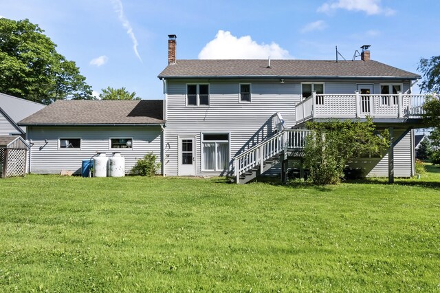 back of property with a lawn and a deck