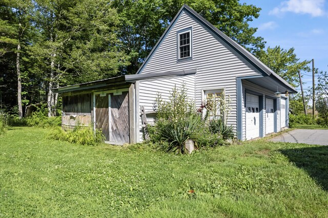 view of home's exterior with a garage and a yard