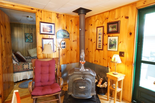 miscellaneous room with wooden walls and a wood stove