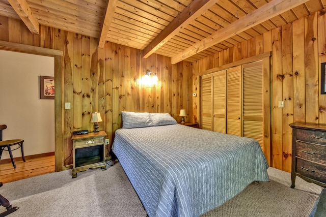 carpeted bedroom with wooden walls, wooden ceiling, and beam ceiling