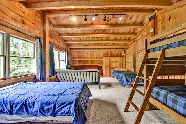 bedroom with wooden walls, carpet floors, lofted ceiling with beams, and wood ceiling