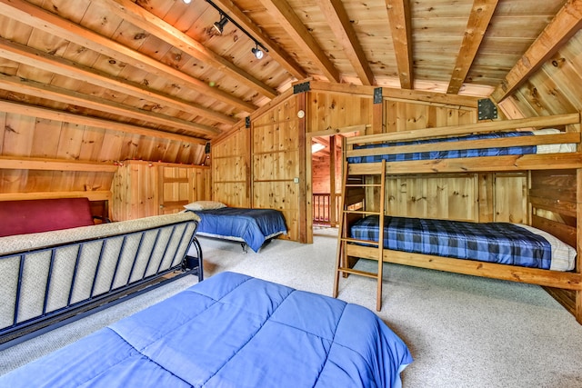 carpeted bedroom with wood ceiling, wood walls, lofted ceiling with beams, and rail lighting