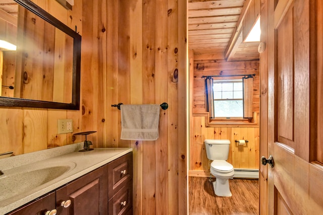 bathroom featuring toilet, hardwood / wood-style flooring, wood walls, baseboard heating, and wooden ceiling