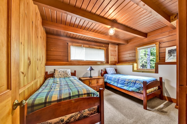 bedroom featuring carpet floors, beam ceiling, wooden walls, and wooden ceiling