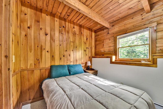 carpeted bedroom with beam ceiling, wood ceiling, and a baseboard heating unit