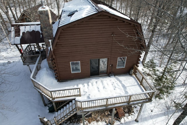 view of snow covered back of property