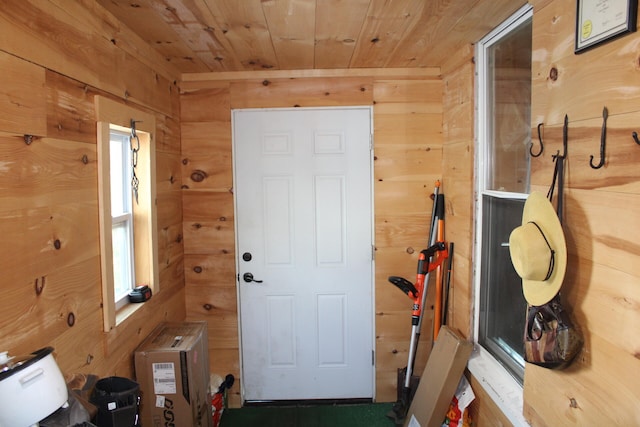 entryway with wooden ceiling and wooden walls