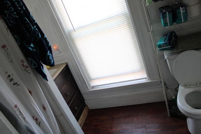 bathroom featuring hardwood / wood-style flooring, toilet, and plenty of natural light