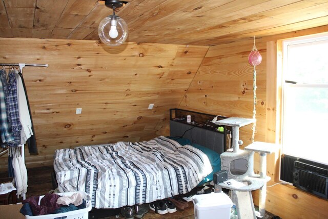 bedroom featuring wood ceiling, wooden walls, and lofted ceiling