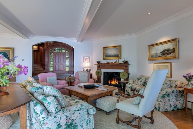 living room featuring ornamental molding, beam ceiling, and hardwood / wood-style flooring