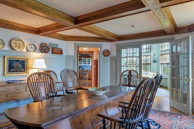 dining space with beamed ceiling, coffered ceiling, and radiator heating unit